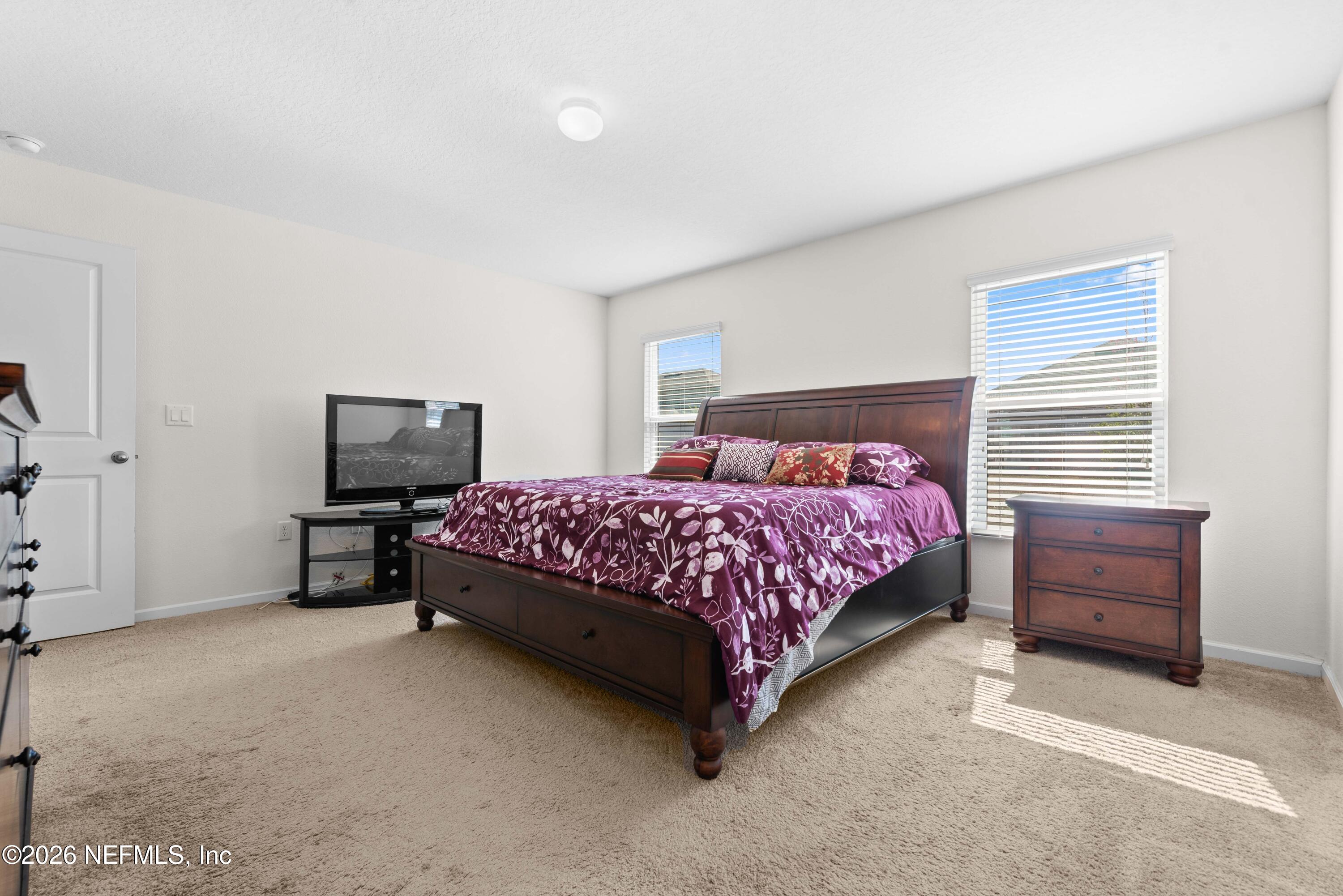 9862 Soldier Court Jacksonville, FL 32221 - Photo 16 of 30 a bedroom with a bed and furniture