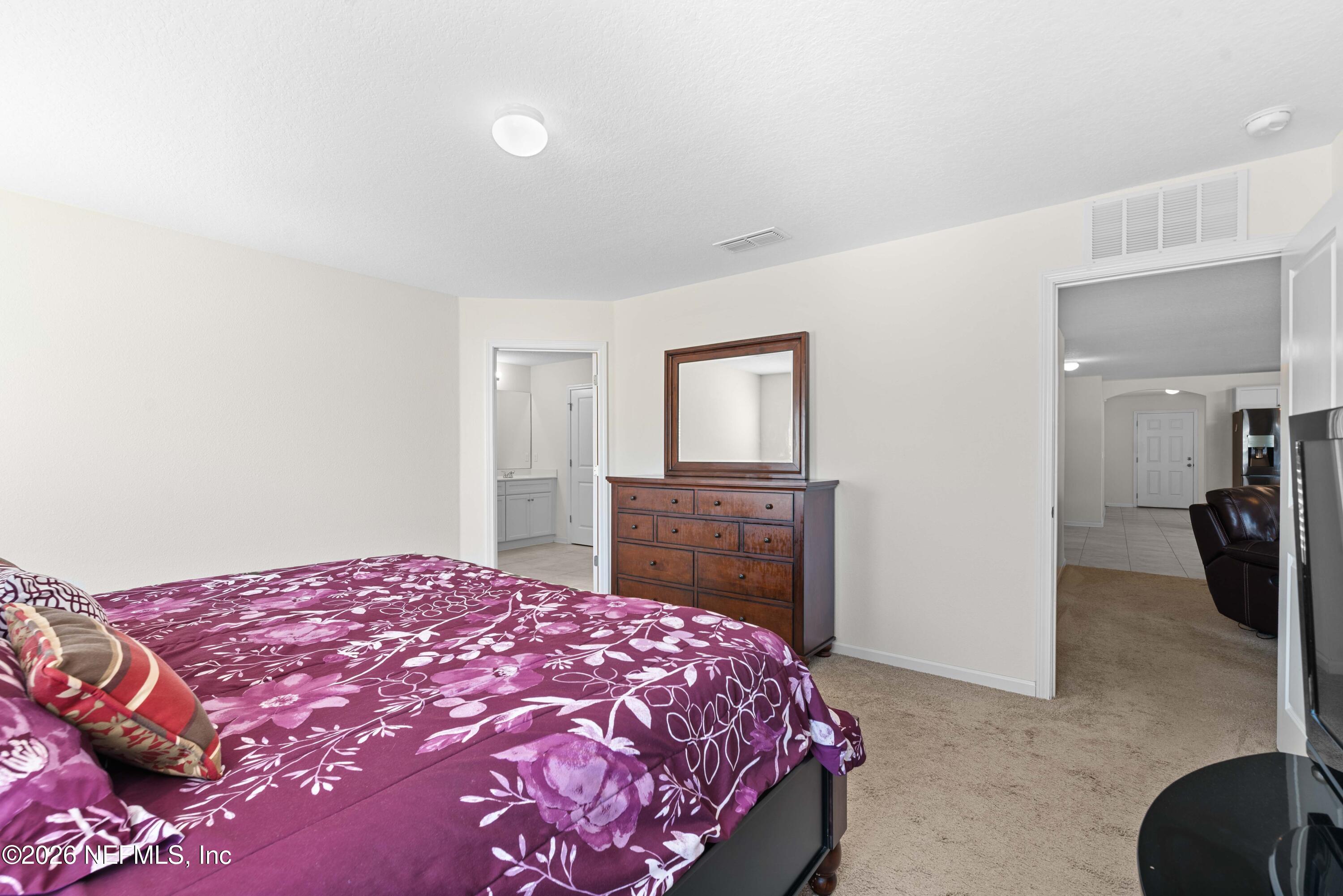 9862 Soldier Court Jacksonville, FL 32221 - Photo 17 of 30 a bedroom with a bed and a dresser