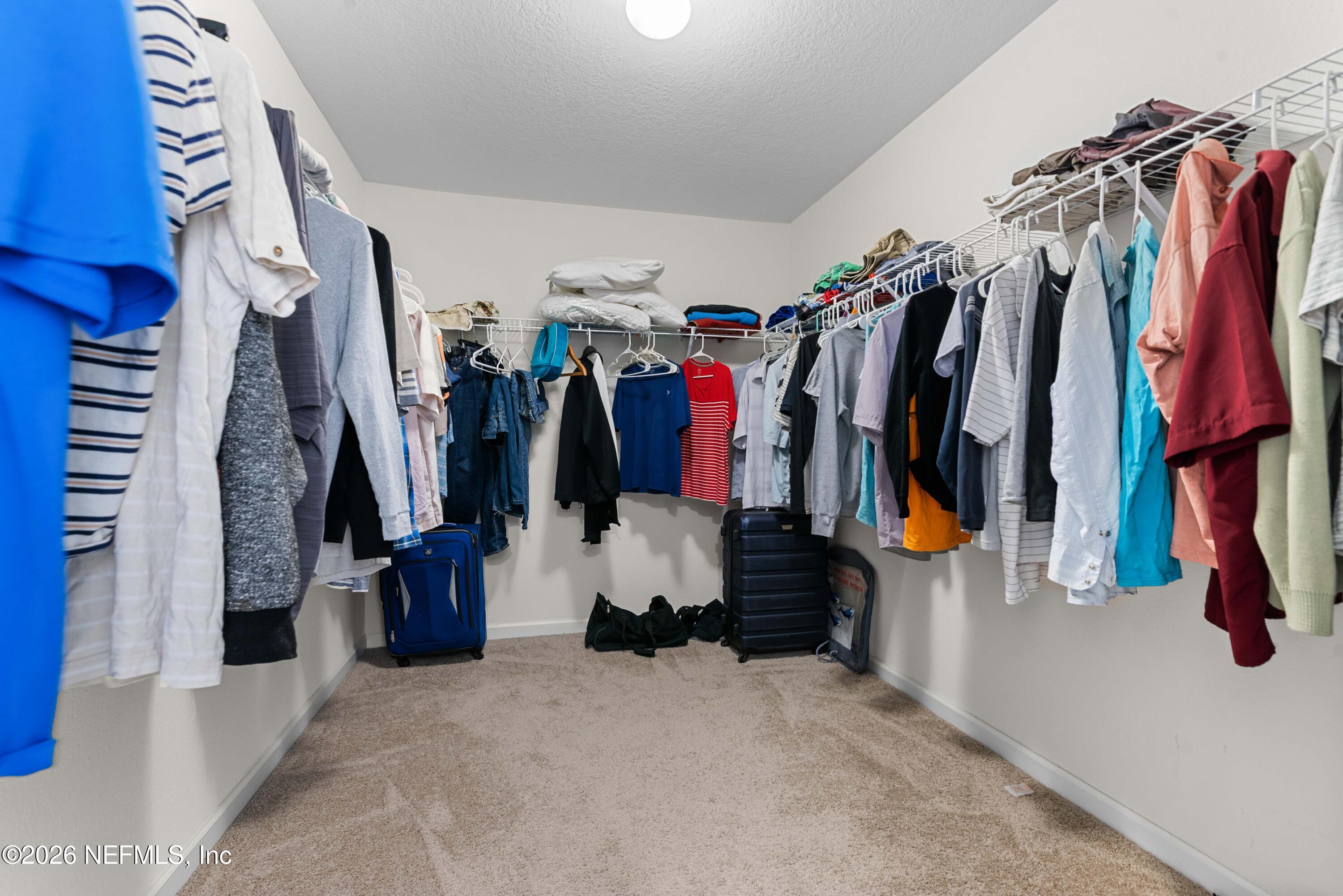 9862 Soldier Court Jacksonville, FL 32221 - Photo 19 of 30 a view of walk in closet with clothes