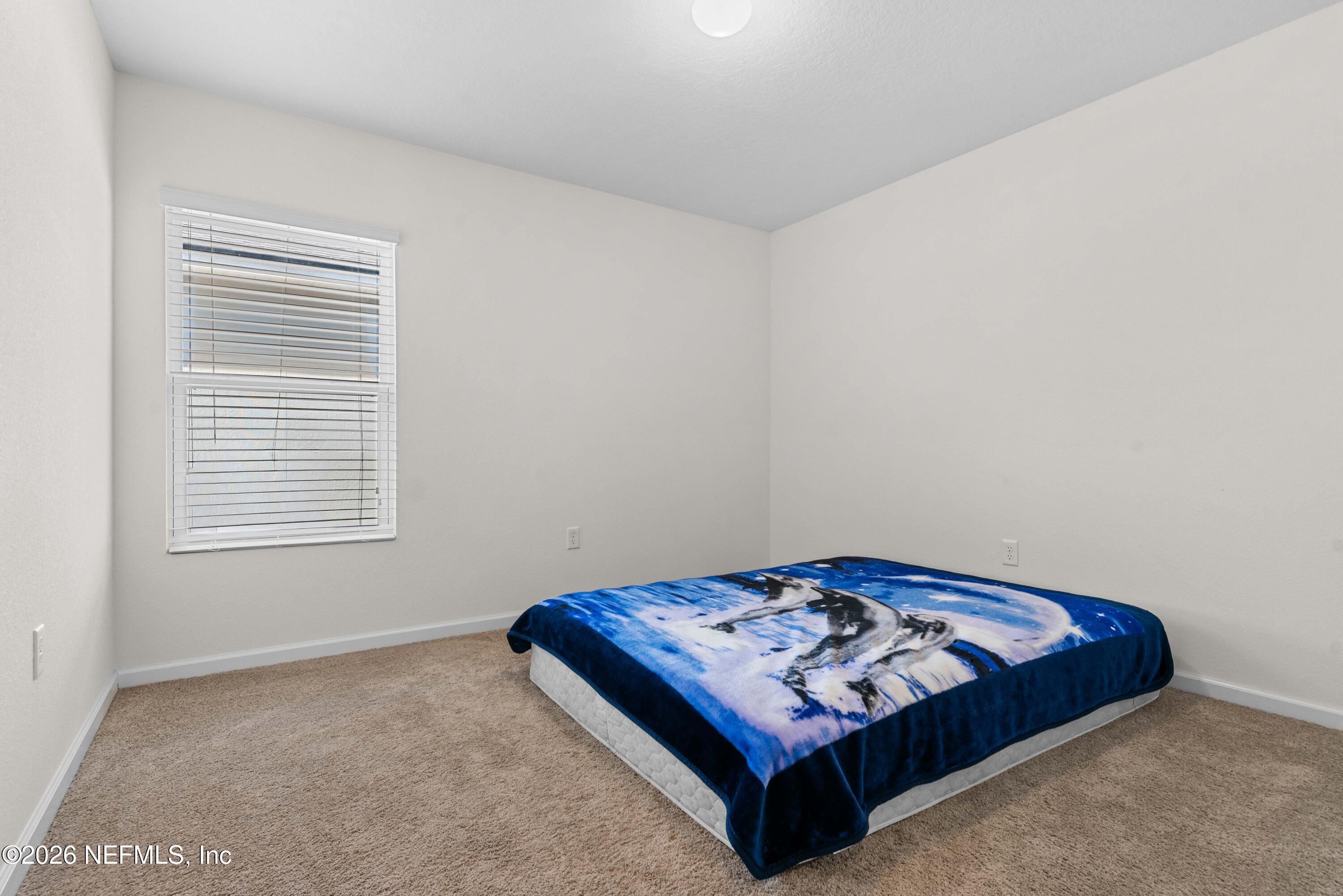 9862 Soldier Court Jacksonville, FL 32221 - Photo 20 of 30 a bedroom with a bed and a window