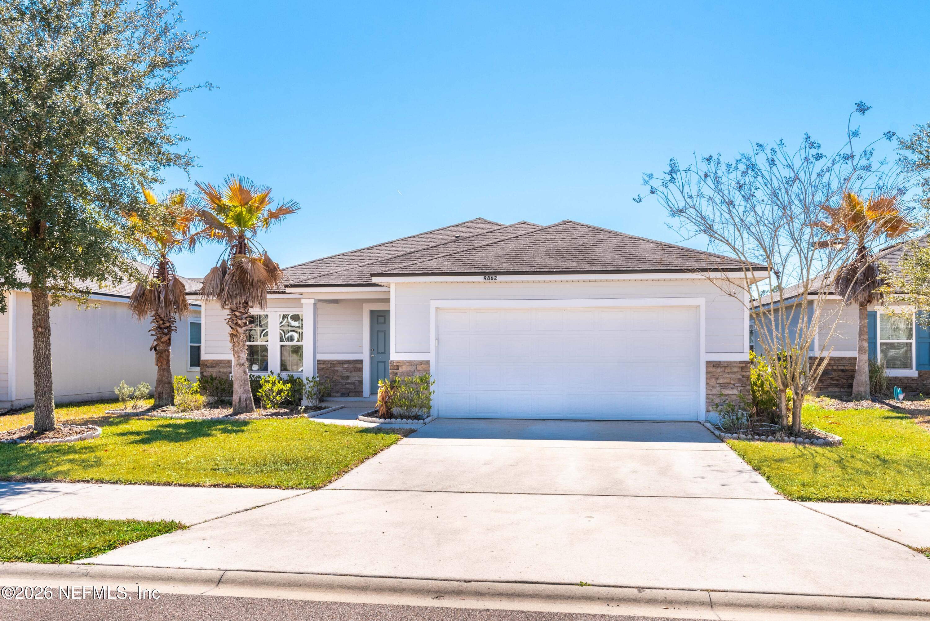 9862 Soldier Court Jacksonville, FL 32221 - Photo 2 of 30 a front view of a house with a yard and garage