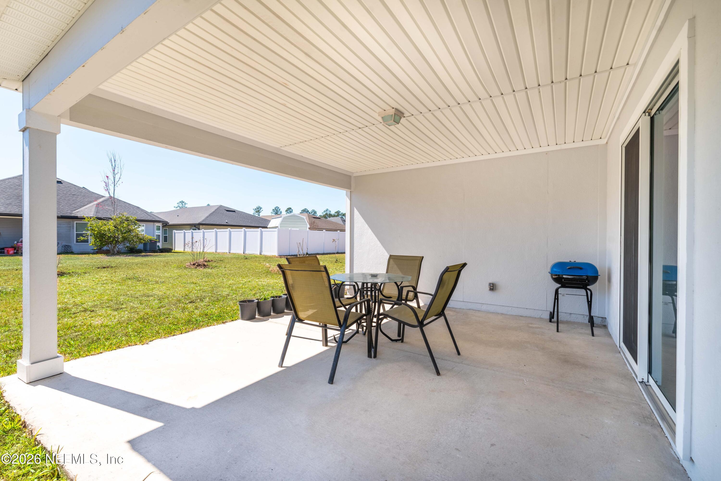 9862 Soldier Court Jacksonville, FL 32221 - Photo 25 of 30 a view of a chairs and table in patio with a backyard