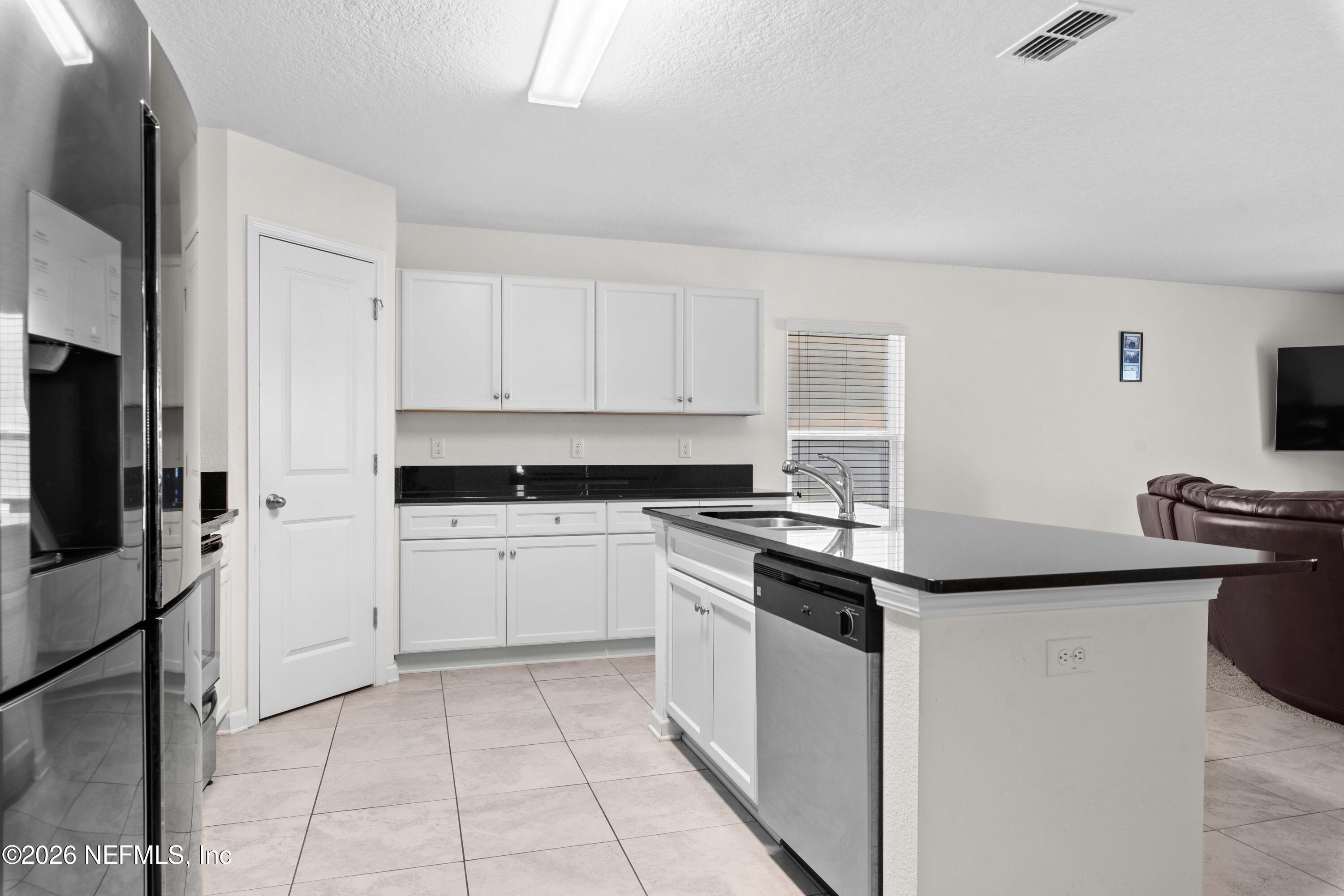 9862 Soldier Court Jacksonville, FL 32221 - Photo 10 of 30 a kitchen with appliances cabinets and a sink