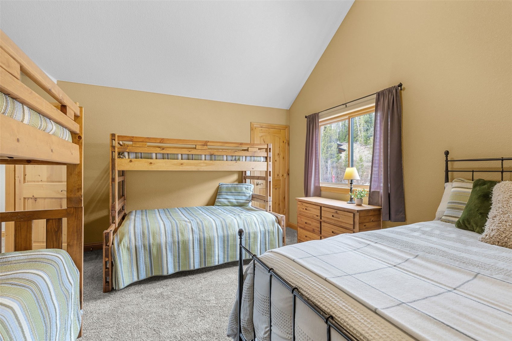 91795 Ryan Gulch Road Silverthorne, CO 80498 - Photo 37 of 50 a bedroom with a large bed and a large window