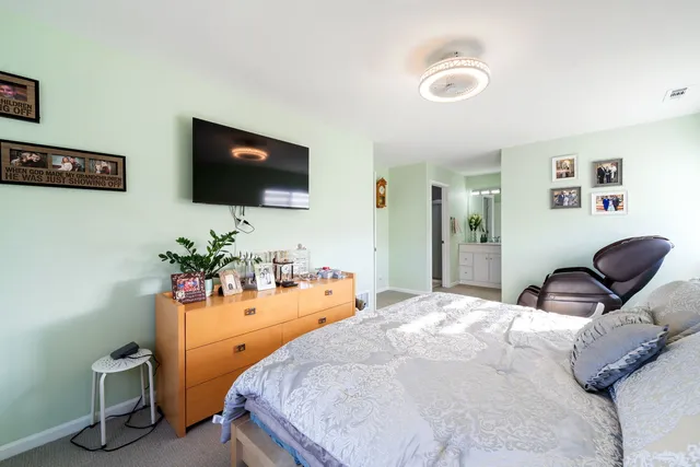 a bedroom with furniture and a flat screen tv
