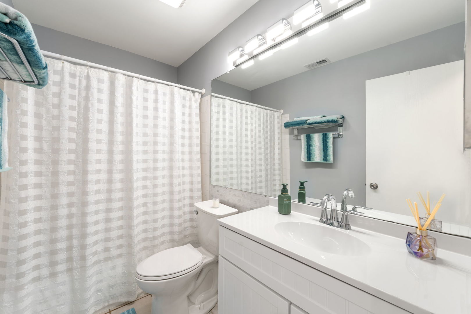 748 Sterling Court, Unit A2 Bartlett, IL 60103 - Photo 18 of 27 a bathroom with a sink a toilet and a mirror