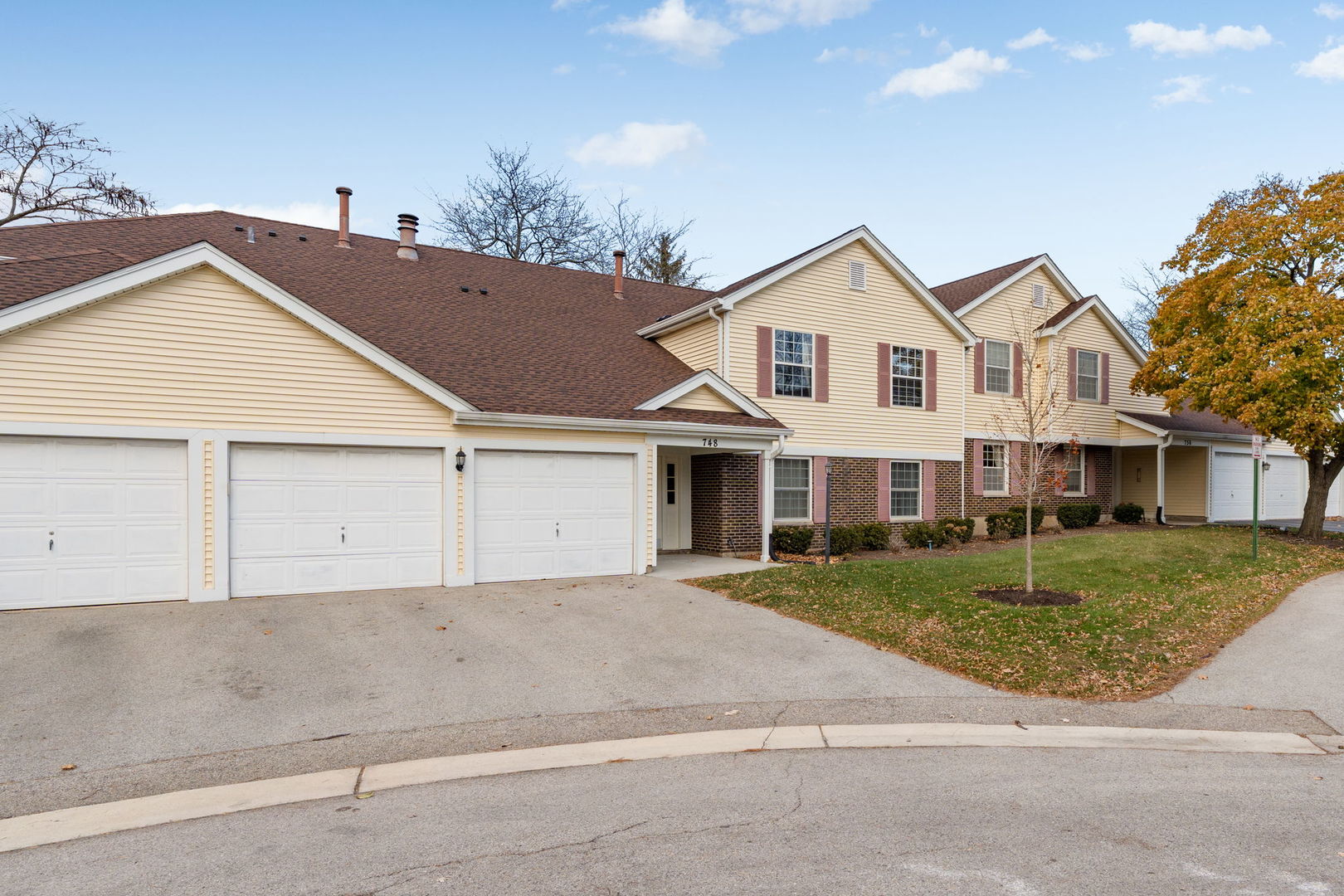 748 Sterling Court, Unit A2 Bartlett, IL 60103 - Photo 2 of 27 a view of house with a yard and potted plants