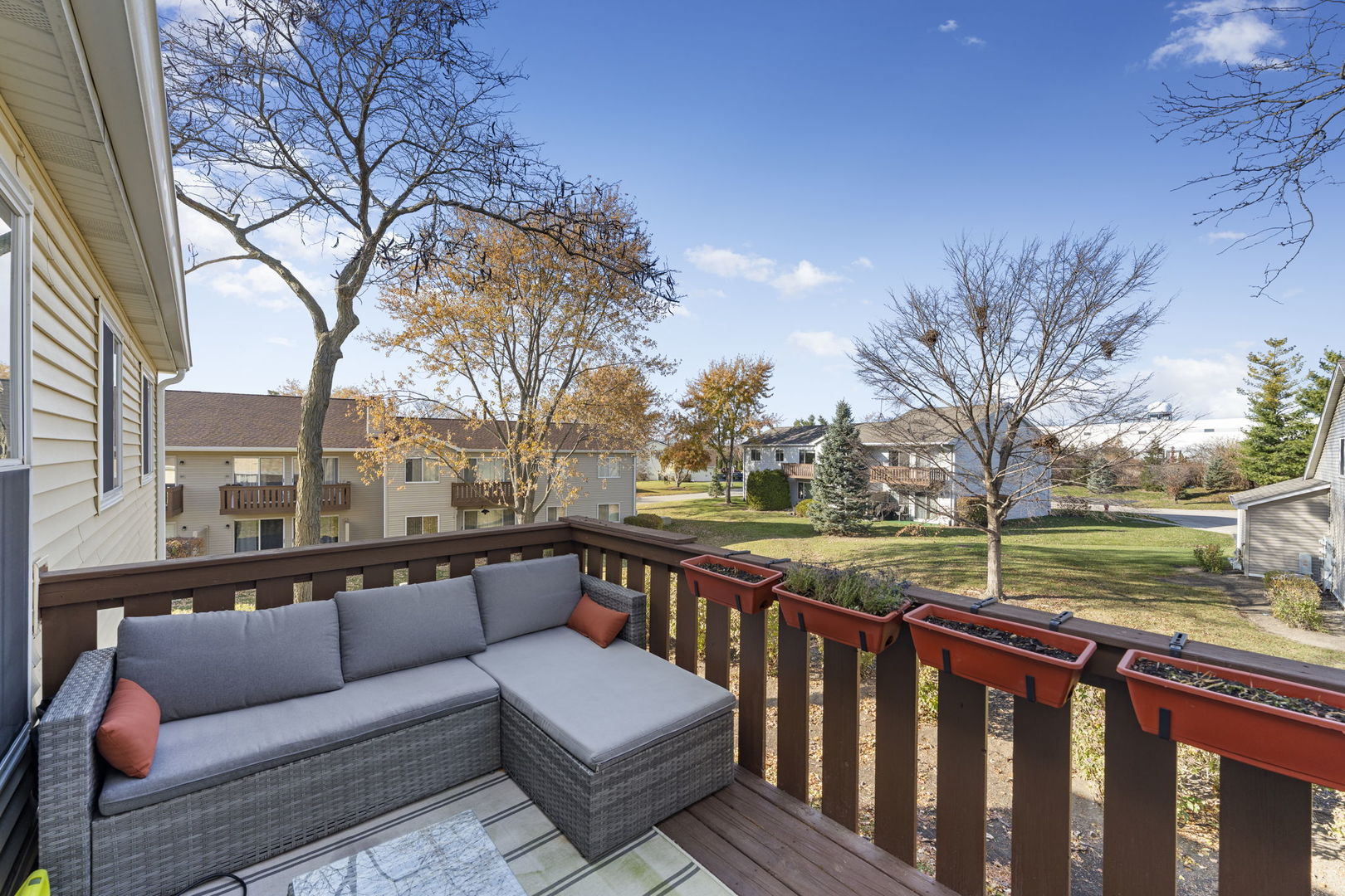 748 Sterling Court, Unit A2 Bartlett, IL 60103 - Photo 21 of 27 a view of roof deck with couches and wooden fence