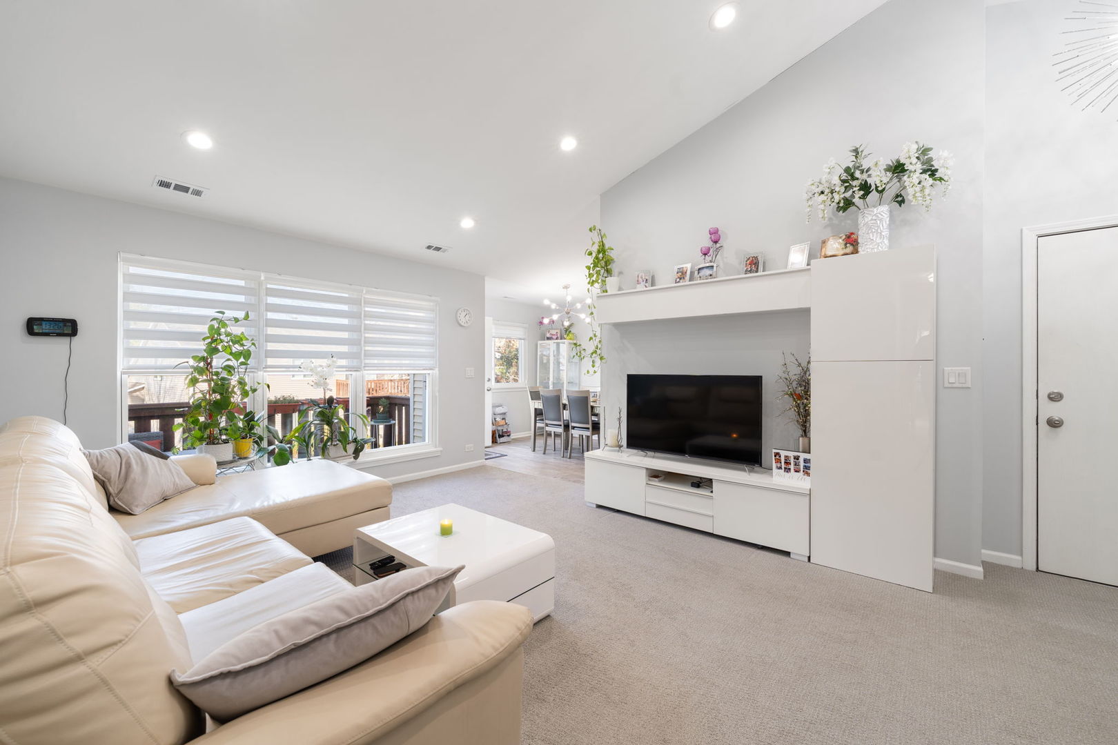748 Sterling Court, Unit A2 Bartlett, IL 60103 - Photo 3 of 27 a living room with furniture a flat screen tv and a fireplace