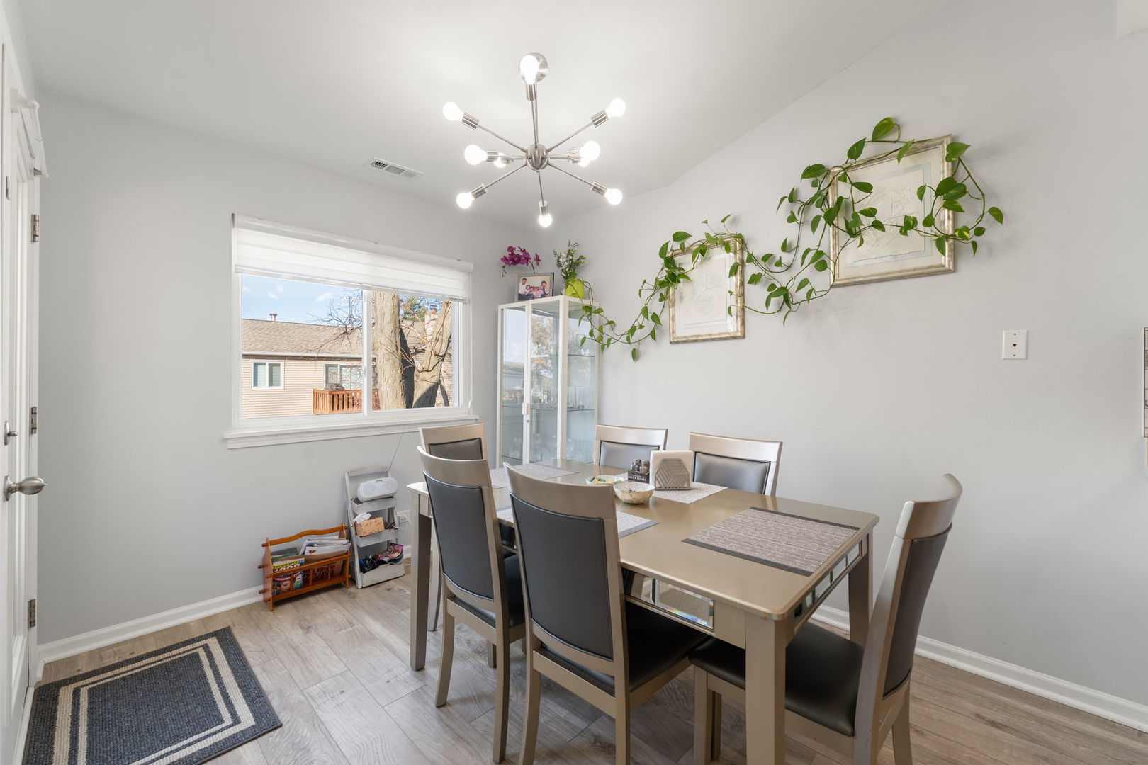748 Sterling Court, Unit A2 Bartlett, IL 60103 - Photo 6 of 27 a view of a dining room with furniture a chandelier and wooden floor