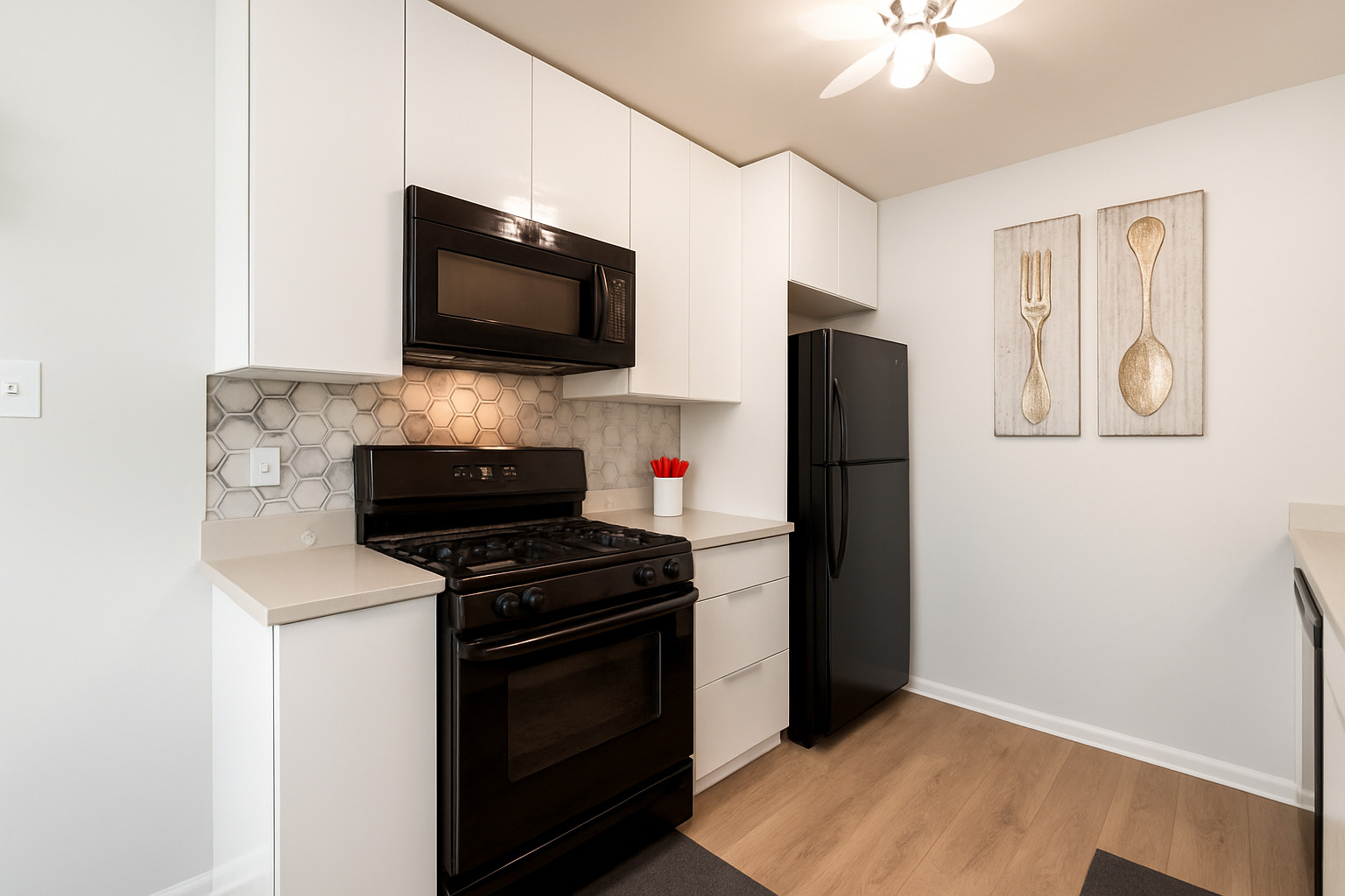 748 Sterling Court, Unit A2 Bartlett, IL 60103 - Photo 8 of 27 a kitchen with a refrigerator stove and microwave