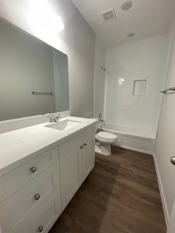 a bathroom with a double vanity sink mirror and toilet