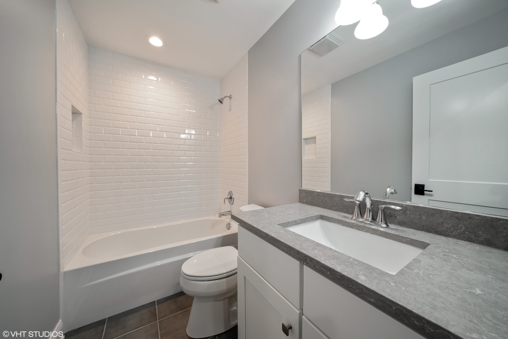 1205 Ridge Road Westmont, IL 60527 - Photo 14 of 16 a bathroom with a granite countertop sink a toilet and bathtub