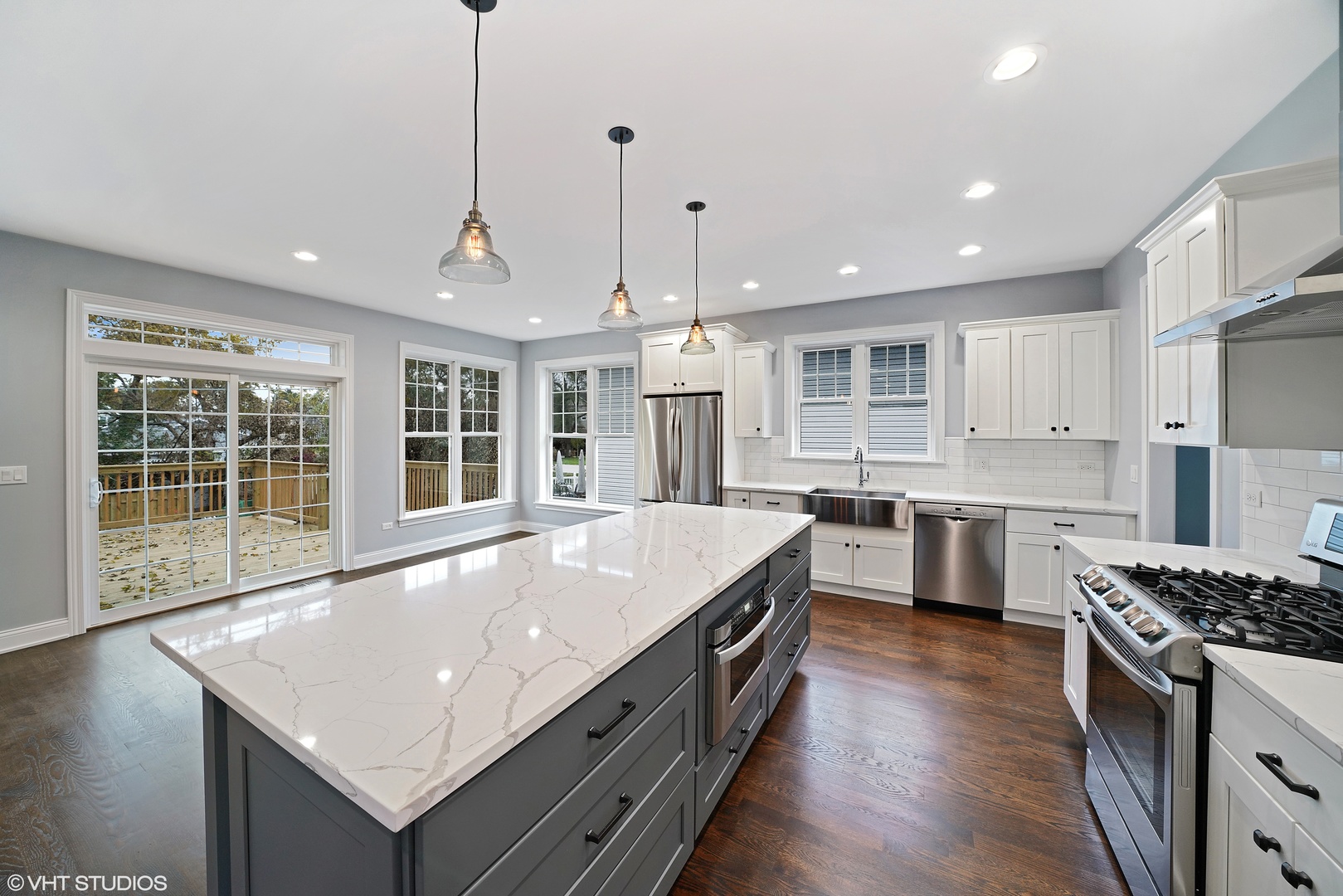 1205 Ridge Road Westmont, IL 60527 - Photo 8 of 16 a large kitchen with kitchen island a stove a sink a center island and wooden floor