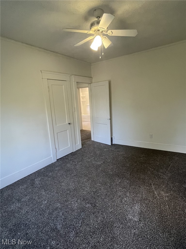 3264 Altamont Road Cleveland, OH 44118 - Photo 14 of 32 Unfurnished bedroom with dark carpet, ceiling fan, and a textured ceiling