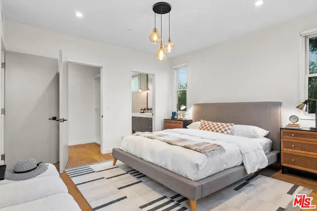 a bedroom with a bed couch and window