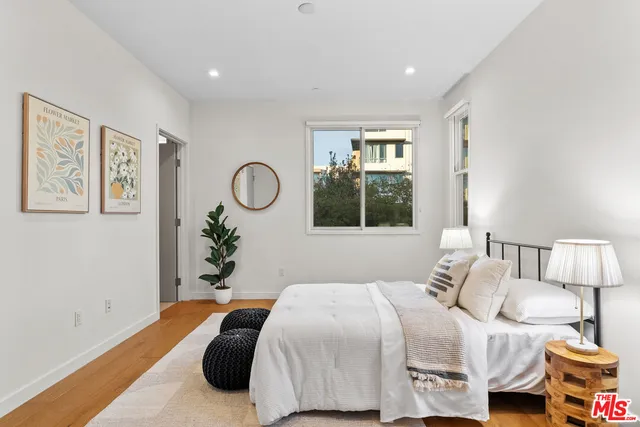 a bedroom with a bed and wooden floor
