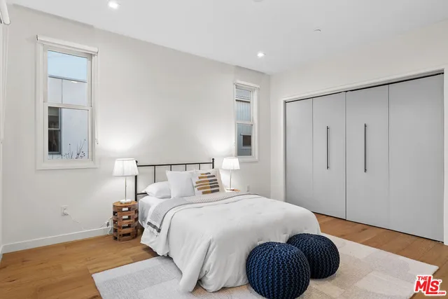 a bedroom with a bed and a painting on the wall