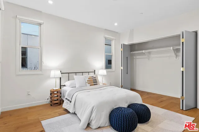 a bedroom with a bed and a painting on the wall