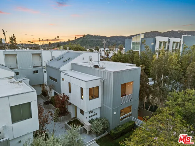 an aerial view of a house with a yard garage and lake view