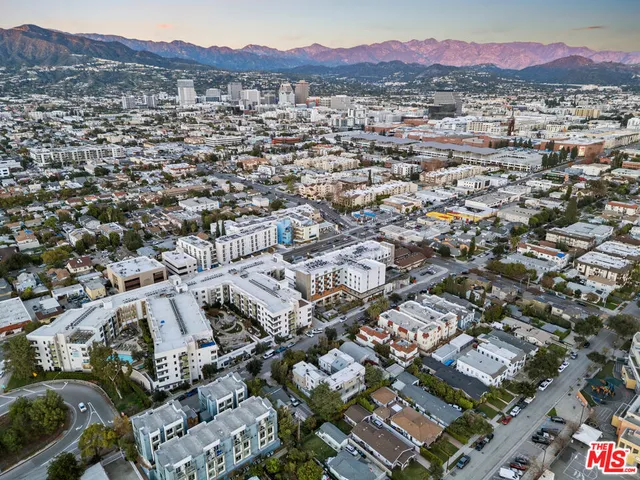 an aerial view of residential houses with city view