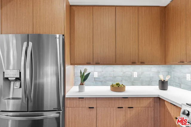 a kitchen with stainless steel appliances granite countertop a refrigerator white stove a sink and dishwasher