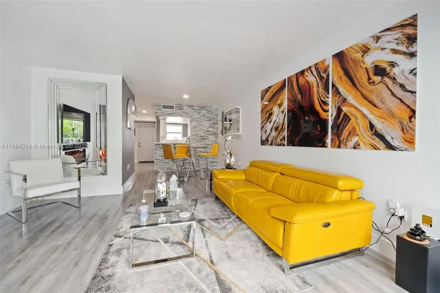a living room with a rug and wooden floor