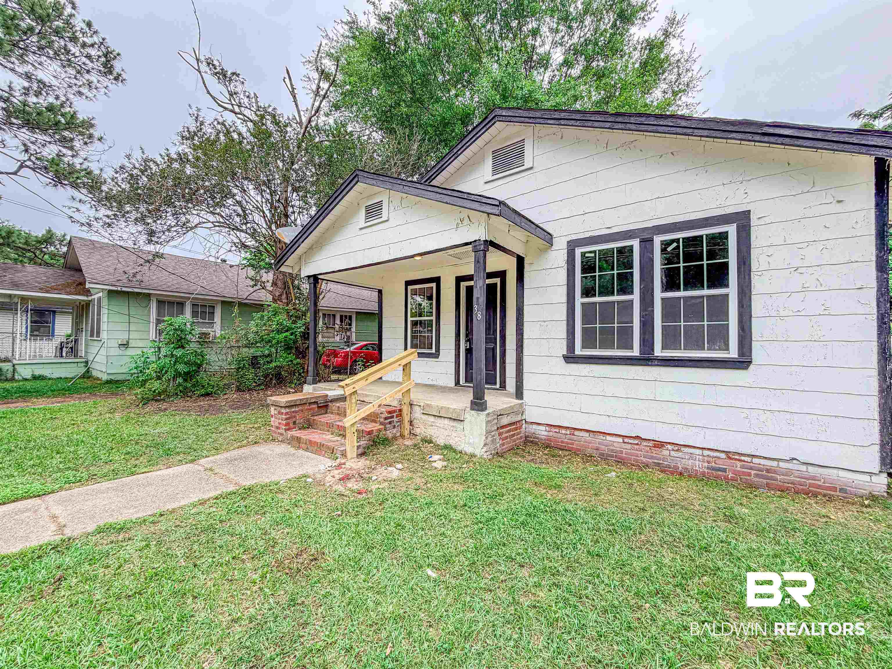 38 Flock Avenue Mobile, AL 36610 - Photo 27 of 27 White siding exterior with dark trim windows
