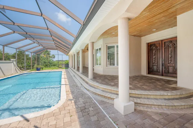 a view of a livingroom with a ceiling fan window and a kitchen