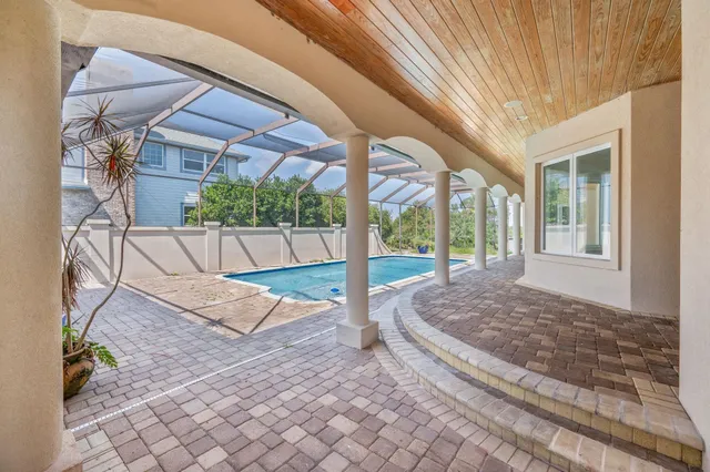 an empty room with windows and fireplace