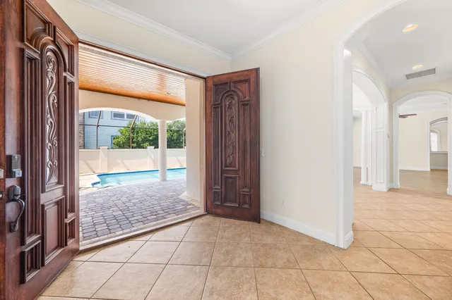a view of a livingroom with a ceiling fan a fireplace and windows