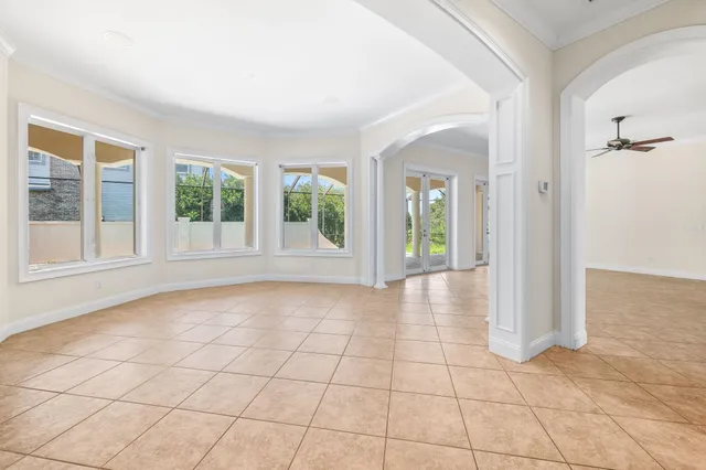 an empty room with fan and windows