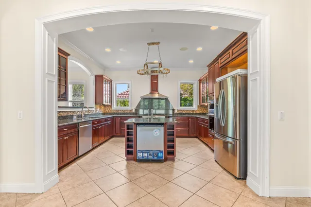 a kitchen with granite countertop cabinets stainless steel appliances and a sink