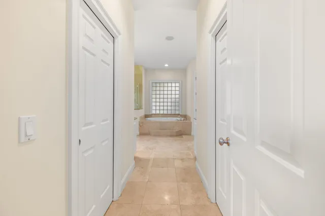 a bathroom with a granite countertop bathtub sink vanity and shower