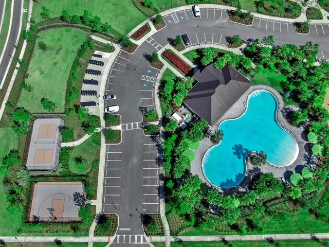 an aerial view of residential houses with outdoor space and street view