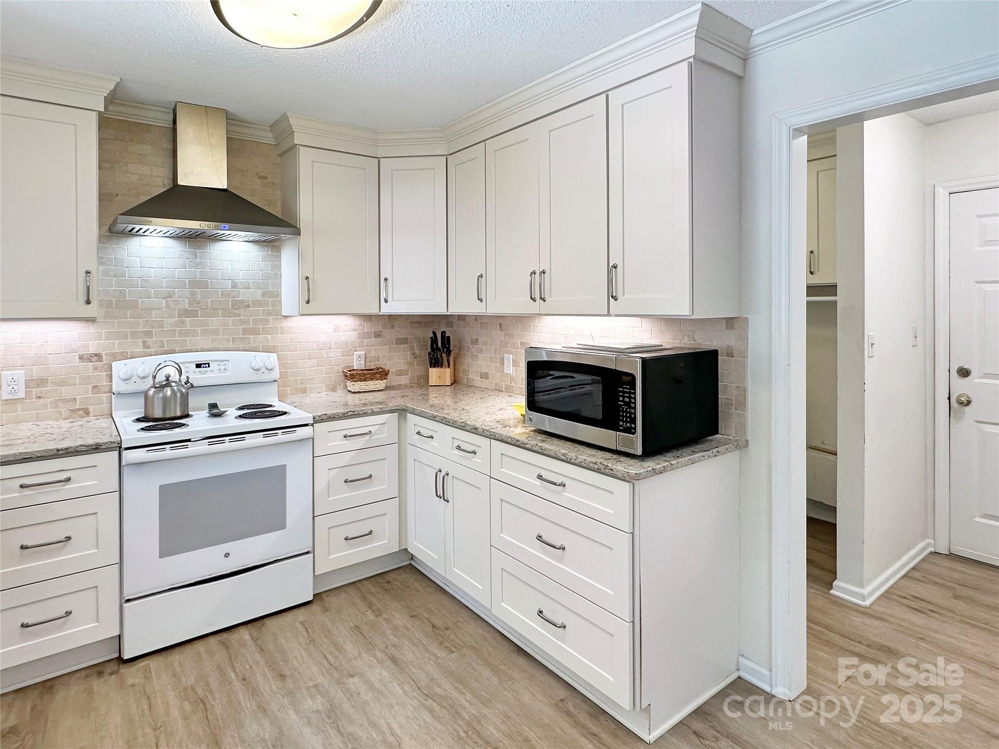 3245 15th Street Northeast Hickory, NC 28601 - Photo 13 of 39 a kitchen with white cabinets and appliances