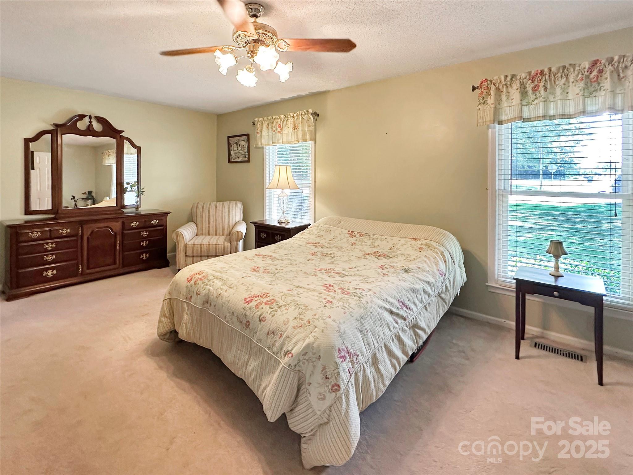 3245 15th Street Northeast Hickory, NC 28601 - Photo 16 of 39 a bedroom with a bed and a dresser with mirror
