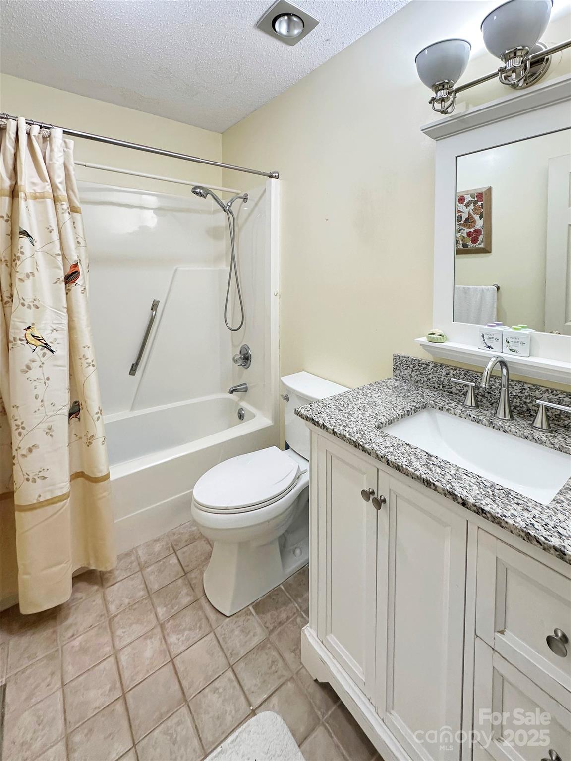 3245 15th Street Northeast Hickory, NC 28601 - Photo 25 of 39 a bathroom with a granite countertop sink toilet a mirror and shower