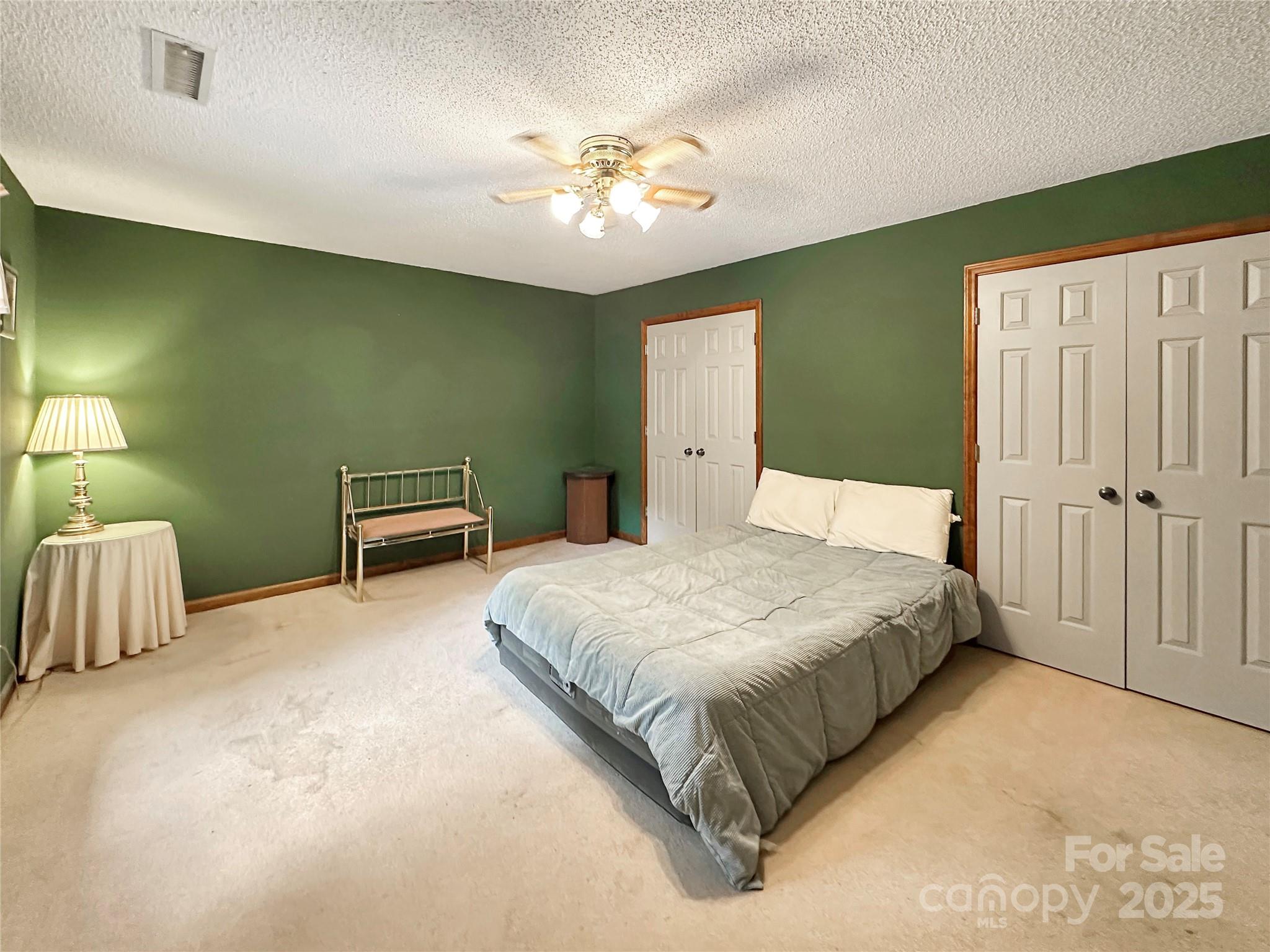 3245 15th Street Northeast Hickory, NC 28601 - Photo 26 of 39 a bedroom with a bed and a chandelier