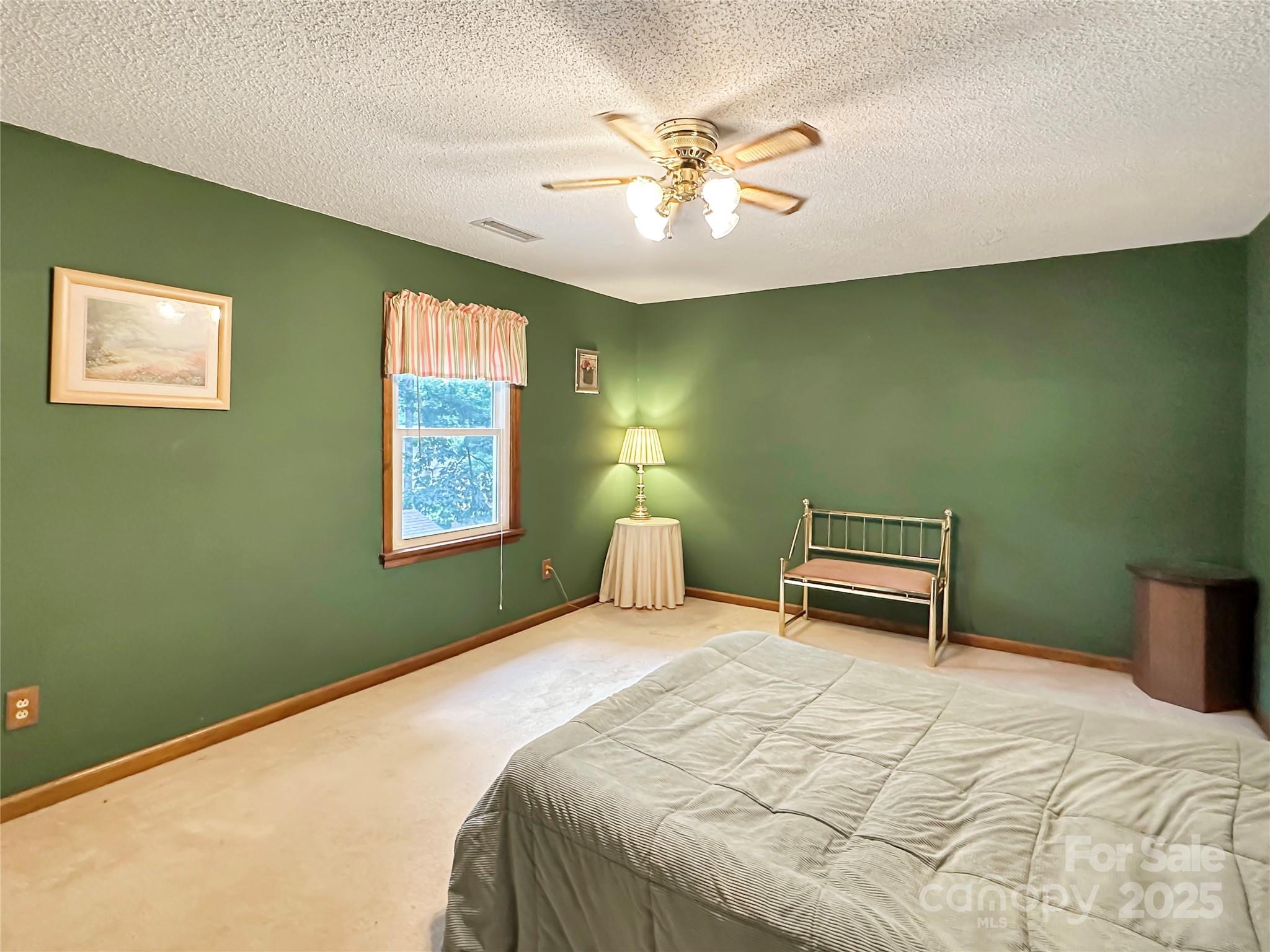 3245 15th Street Northeast Hickory, NC 28601 - Photo 27 of 39 a bedroom with a bed and a chandelier