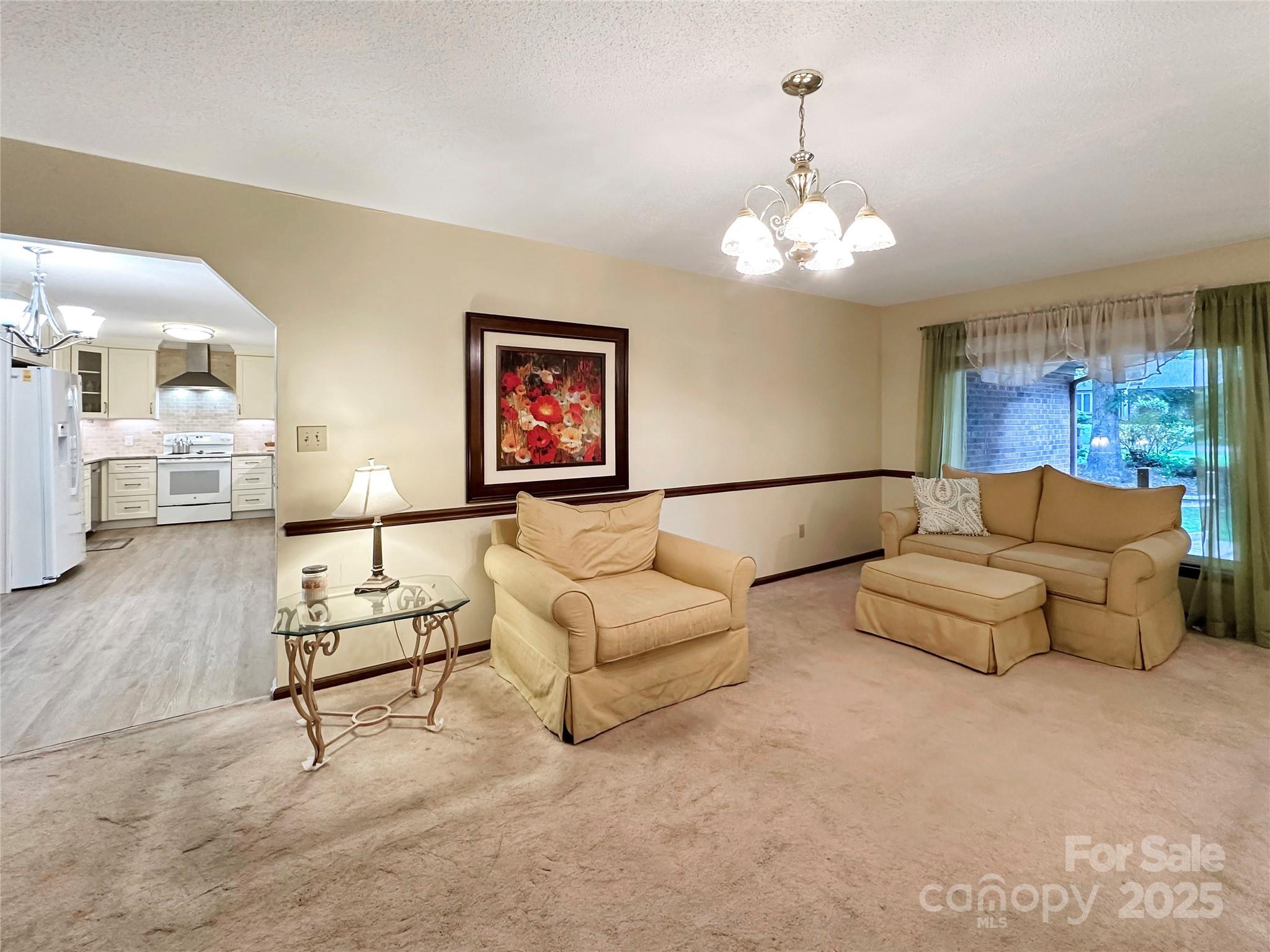 3245 15th Street Northeast Hickory, NC 28601 - Photo 8 of 39 a living room with furniture and a chandelier