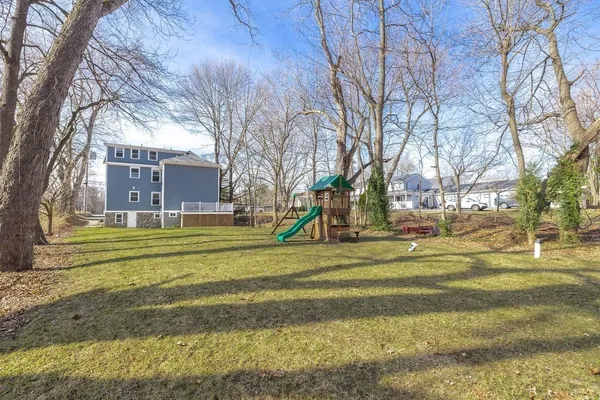 a view of a playground with a large trees