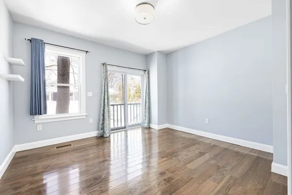 wooden floor in an empty room with a window