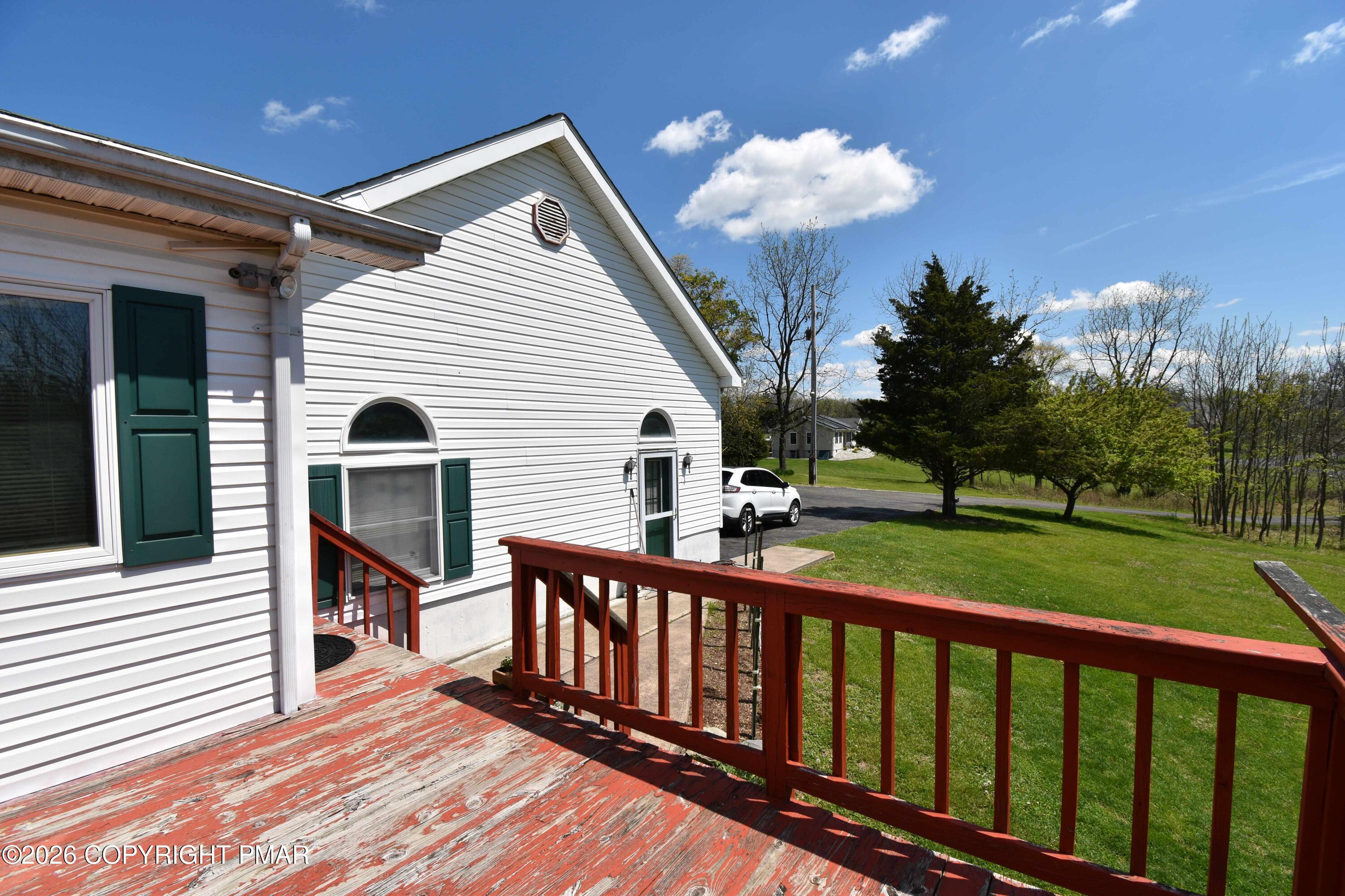 160 Quiet Valley Road Mount Bethel, PA 18343 - Photo 8 of 44 a view of a house with a small yard and deck area with wooden floor