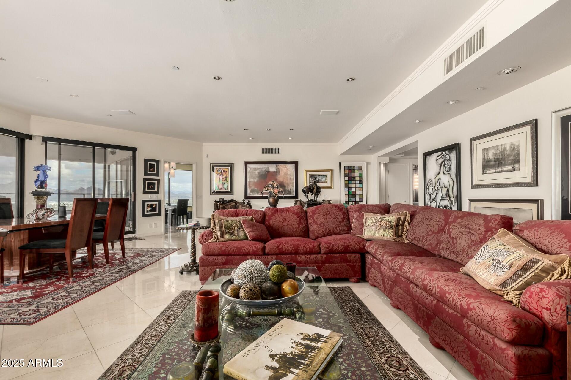 1040 East Osborn Road, Unit 1803 Phoenix, AZ 85014 - Photo 11 of 44 a living room with furniture ceiling fan and a rug