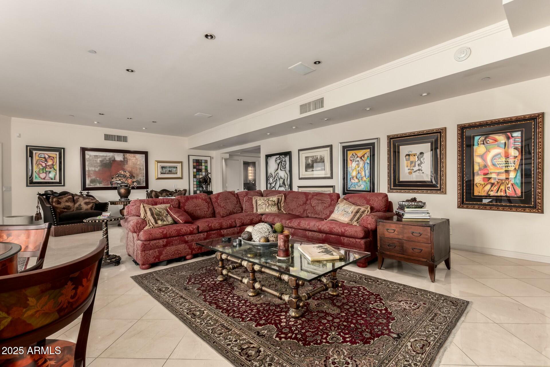 1040 East Osborn Road, Unit 1803 Phoenix, AZ 85014 - Photo 12 of 44 a living room with lots of furniture and a rug