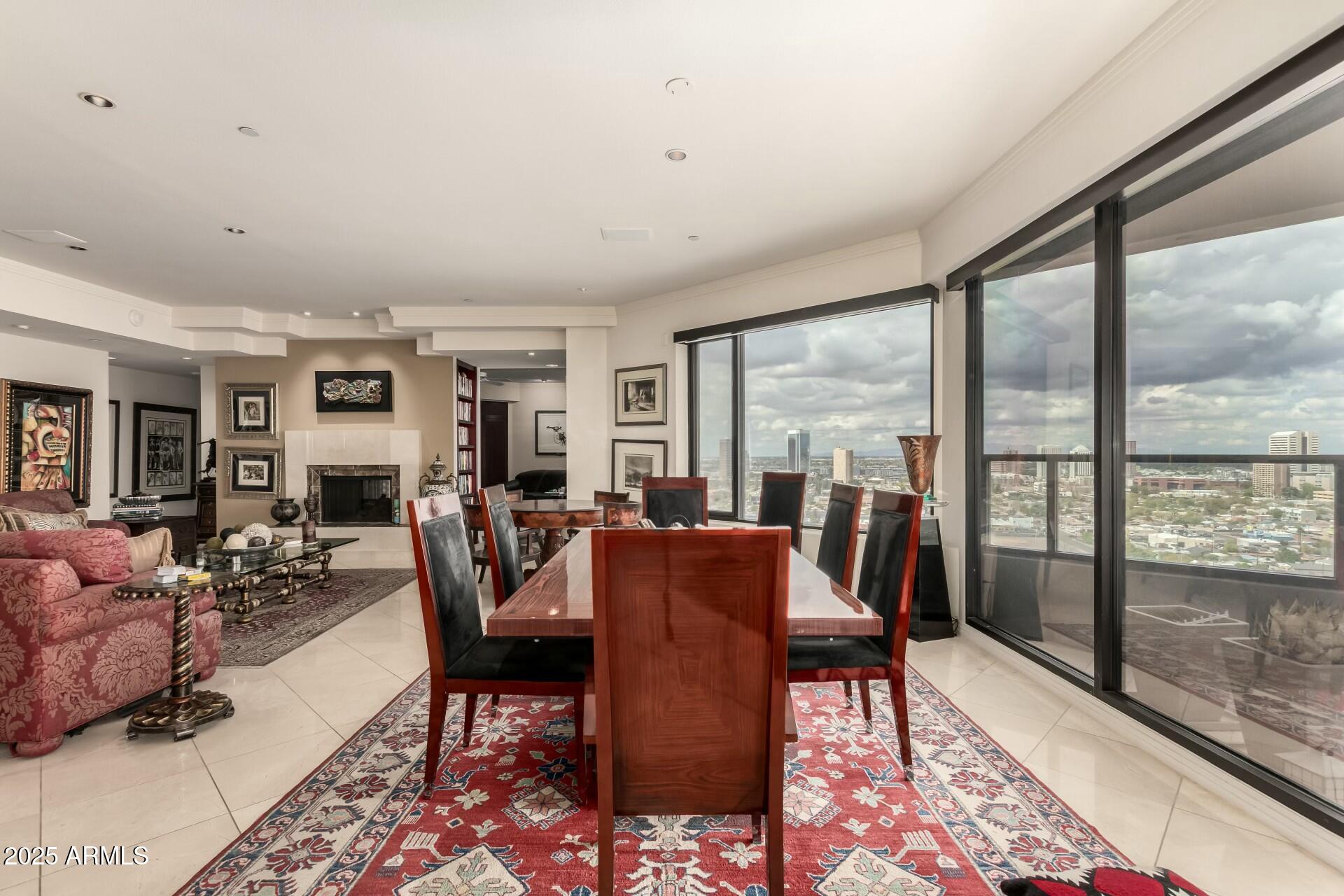 1040 East Osborn Road, Unit 1803 Phoenix, AZ 85014 - Photo 13 of 44 a living room with furniture large windows and wooden floor