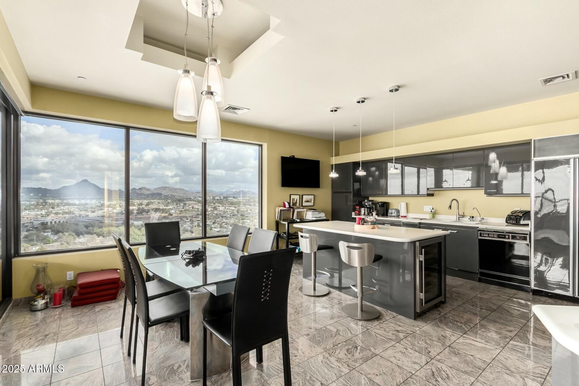 1040 East Osborn Road, Unit 1803 Phoenix, AZ 85014 - Photo 18 of 44 a view of a dining room with furniture window and outside view