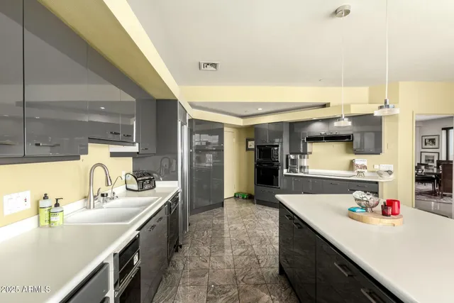 a large kitchen with a large counter top furniture and appliances