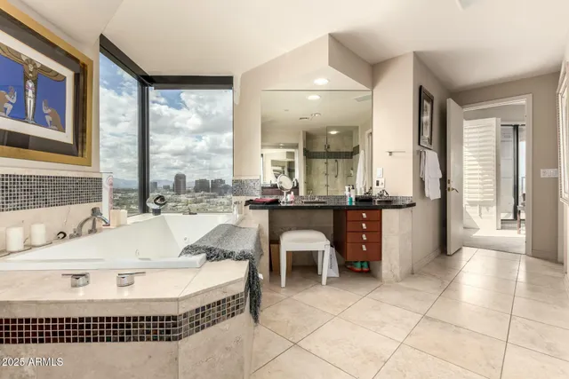 a bathroom with a sink and mirror with shower